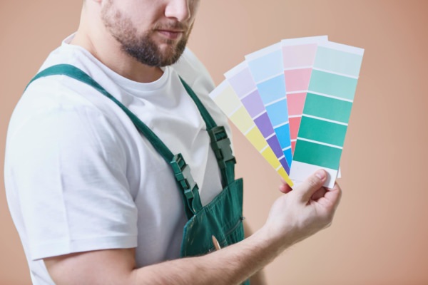 Maler mit Farbvorlagen in der Hand